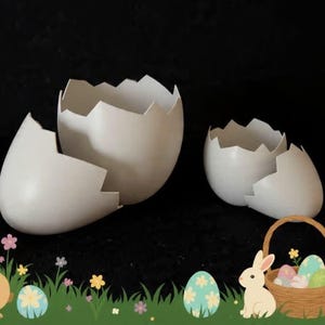 May include: Two white, cracked eggshell decorations are the focal point of this image. A cartoon bunny, Easter eggs, and a basket of eggs are also present, suggesting an Easter theme. The background is black.