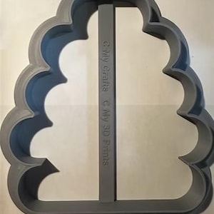 May include: A gray plastic cookie cutter in the shape of a stylized tree. The cutter has a scalloped edge and a vertical support bar. The text "© My Crafts © My 3D Prints" is printed vertically on the support bar.