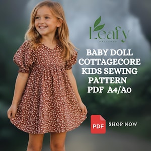 May include: A young girl wearing a brown baby doll dress with a floral pattern. The dress has short, puffed sleeves and a V-neck. Text on the image reads "Leafy Patterns, Baby Doll Cottagecore Kids Sewing Pattern PDF A4/A0". A red PDF icon is also visible.