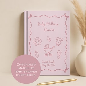 K&ouml;nnte beinhalten: Ein rosa G&auml;stebuch f&uuml;r eine Babyparty mit dem Text "Baby Miller's Shower" und Illustrationen von Babyartikeln. Das Buch enth&auml;lt das Datum "5. Mai 2026" und den Text "Guest Book". Ein goldener Stift liegt auf dem Tisch.