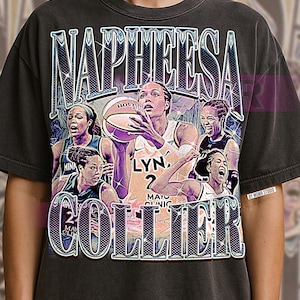 May include: Dark gray t-shirt featuring a graphic of Napheesa Collier, a basketball player, holding a basketball. The design includes the text "NAPHEESA COLLIER" in a stylized font, along with other players and team details.