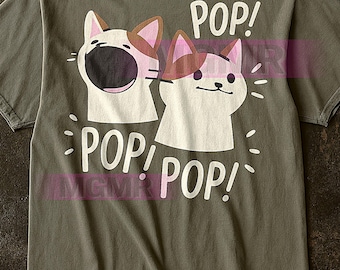 Puede incluir: Camiseta verde oliva con un gráfico de dos gatos de dibujos animados y la palabra "POP!" en blanco. Los gatos tienen caras blancas, orejas marrones y bocas abiertas. La palabra "POP!" se repite debajo.