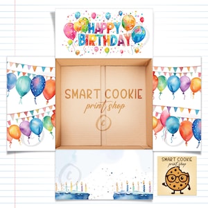 May include: A cardboard box with a watercolor design. The top flap reads "Happy Birthday" with colorful balloons. The inside of the box has the text "Smart Cookie print shop". The sides of the box are decorated with watercolor balloons and pennant banners.