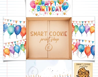 May include: A cardboard box with open flaps featuring watercolor illustrations of colorful balloons, bunting banners, and birthday cakes with candles. The interior base displays the text SMART COOKIE print shop and a circular copyright symbol.