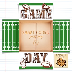 May include: A football-themed cardboard box featuring green and white football field designs, the words "GAME DAY", and football illustrations. The box also displays the text "SMART COOKIE print shop".