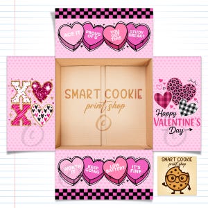 May include: An open pink Valentine's Day gift box with a variety of heart-shaped designs and text. The box features phrases like "Ace It," "Proud of U," and "Happy Valentine's Day." The "Smart Cookie print shop" logo is also visible.