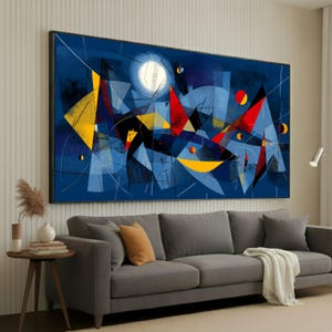 May include: Abstract art print featuring a geometric design in shades of blue, yellow, and red. The artwork includes a large white circle resembling a moon, with various shapes and lines creating a dynamic composition. The canvas is framed in black.