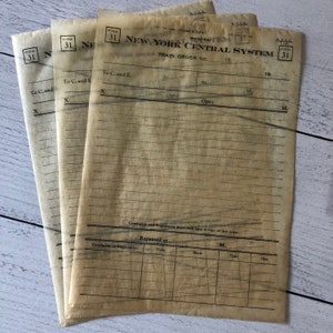 May include: Three vintage New York Central System train order forms. Each form is printed on aged, tan paper with black text and lines. The forms include the text "FORM 31" and "ORDER TRAIN ORDER NO."