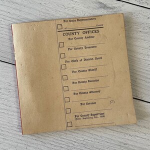May include: A vintage tan paper booklet with red binding, featuring the text "COUNTY OFFICES" and checkboxes for various county positions. The booklet includes text for County Auditor, Treasurer, Clerk, Sheriff, Recorder, Attorney, Coroner, and Supervisor.