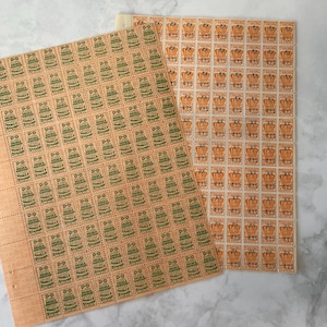 May include: Two sheets of vintage stamps. One sheet features green text and graphics on a peach background, with the text "D-D WORLD STAMP". The other sheet has orange text and graphics with the text "TRADING STAMP".
