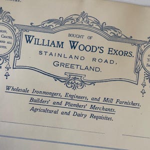 May include: Cream-colored paper with ornate blue text. The text reads "WILLIAM WOOD'S EXORS." and lists the address in Greetland. Additional text includes "Wholesale Ironmongers, Engineers, and Mill Furnishers."