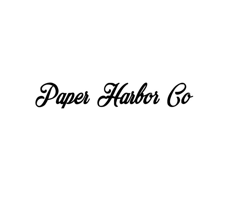 May include: The words "Paper Harbor Co" are written in a cursive font in black against a white background. The lettering has a classic, elegant style.