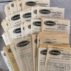 May include: A collection of vintage invoices from Colonial Baking Company, featuring the company logo and handwritten details. The invoices are printed on aged, off-white paper, with some showing dates and amounts. The invoices are from Des Moines, Iowa.