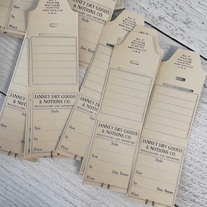 Antieke Janney Dry Goods & Notions Co. groothandelaren en importeurs opvouwbare pin-ticket-tags