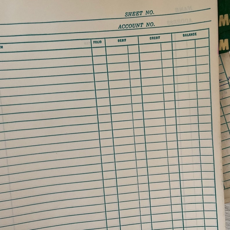 May include: A close-up of a ledger sheet with a grid of horizontal and vertical lines. The sheet is off-white with green lines and text at the top that reads "SHEET NO." and "ACCOUNT NO."