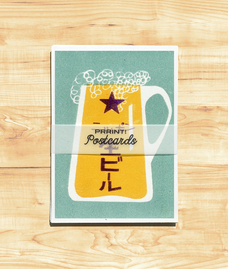 May include: A vintage-style postcard featuring a yellow beer stein with a star and the Japanese word "ビール" (beer) in white. The postcard has a teal background and a white banner that reads "PRRINT! Postcards - SET OF 6".