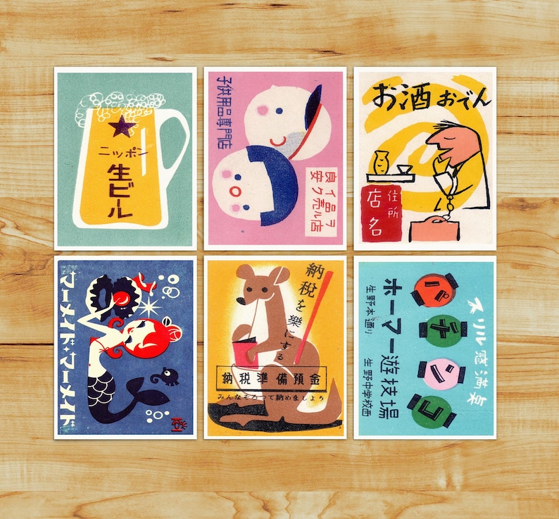 May include: Nine vintage matchbox labels with colorful illustrations and Japanese text. The labels feature a beer bottle, a kangaroo, a mermaid, a man with a drink, a couple, and a game of bowling.