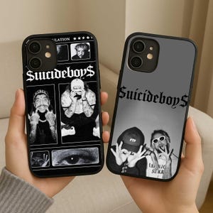 May include: Two black phone cases with the text "Suicideboy$". One case features a collage of black and white images, the other has a grayscale photo of two people. Both cases have a black border.