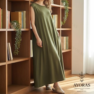 Neutral beige sleeveless long cotton dress with flowy hemline, minimalist chic style