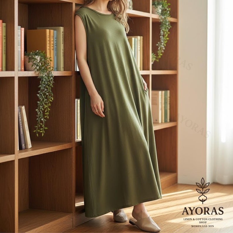 Neutral beige sleeveless long cotton dress with flowy hemline, minimalist chic style
