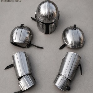 May include: A set of silver-colored metal armor pieces, including a helmet, two shoulder guards, and two arm guards. The helmet has a T-shaped visor. The arm and shoulder guards have black leather straps.