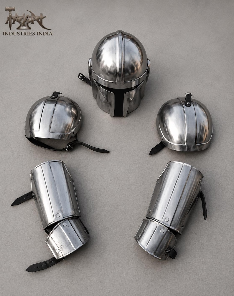 May include: A set of silver-colored metal armor pieces, including a helmet, two shoulder guards, and two arm guards. The helmet has a T-shaped visor. The arm and shoulder guards have black leather straps.
