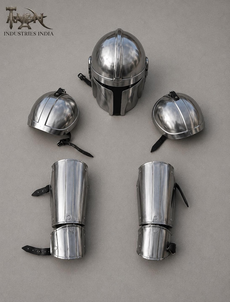 May include: A set of polished metal armor pieces, including a helmet, two shoulder pieces, and two arm guards. The helmet has a distinctive T-shaped visor. The arm guards and shoulder pieces have leather straps. The logo "INDUSTRIES INDIA" is visible in the top left corner.