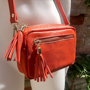 Small orange leather bag. GENUINE leather shoulder or cross body bag. Bright orange leather purse with tassels, adjustable strap and zipper