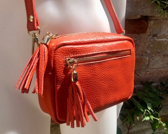 Small orange leather bag. GENUINE leather shoulder or cross body bag. Bright orange leather purse with tassels, adjustable strap and zipper