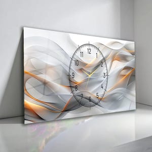 May include: A rectangular wall clock with an abstract design. The background features flowing white, gray, and orange shapes. A black clock face with gold hands is centered on the design, displaying the time.