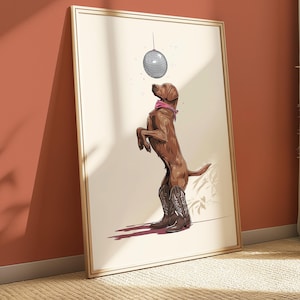 May include: Framed art print showing a brown dog on its hind legs, wearing cowboy boots and a pink bandana. A disco ball hangs above the dog. The artwork has a light background and a gold frame.