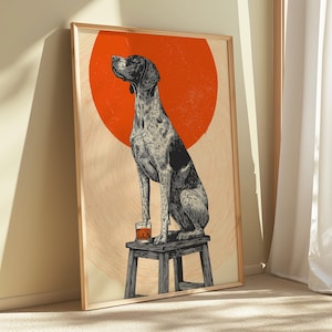 May include: Framed art print featuring a stylized illustration of a dog sitting on a small wooden stool with a glass of amber liquid. The dog is black and white with a red circle in the background. The artwork is in a wooden frame.