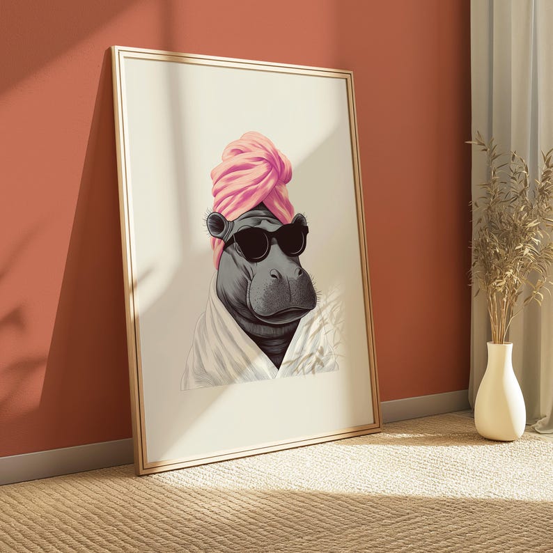 May include: A framed art print featuring a hippo wearing sunglasses and a pink turban. The hippo is also wearing a white robe. The artwork is leaning against a red wall, with a vase of dried plants in the background.
