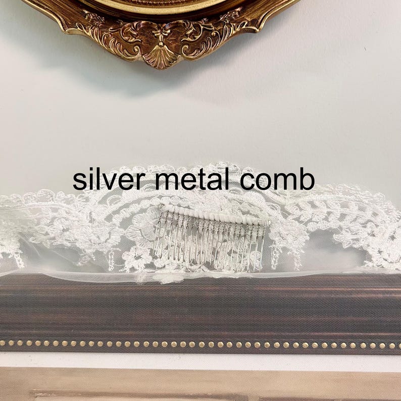 May include: A bridal veil with a silver metal comb. The veil is white and has a delicate lace trim. The comb is made of silver metal and is attached to the veil. The text "silver metal comb" is displayed on the image.