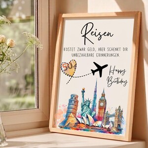 May include: A framed print with the word "Reisen" and the text "KOSTET ZWAR GELD, ABER SCHENKT DIR UNBEZAHLBARE ERINNERUNGEN." A heart with the number "50" and a plane graphic are featured. The print also says "Happy Birthday" and depicts famous landmarks.