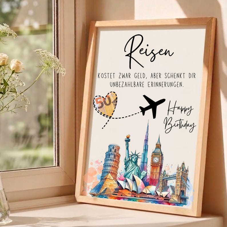 May include: A framed print with the word "Reisen" and the text "KOSTET ZWAR GELD, ABER SCHENKT DIR UNBEZAHLBARE ERINNERUNGEN." A heart with the number "50" and a plane graphic are featured. The print also says "Happy Birthday" and depicts famous landmarks.
