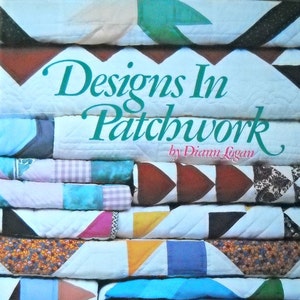 May include: A stack of colorful patchwork quilts, featuring various geometric designs in shades of blue, pink, yellow, and brown. The book cover, "Designs In Patchwork" by Diann Logan, is visible, along with the text "30 Bright New Quilts for Machine Piecing."