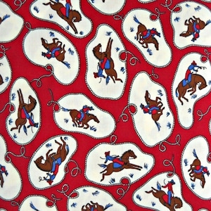 May include: A red fabric featuring a repeating pattern of white, rope-bordered oval shapes. Inside each oval, a brown horse is depicted with a rider wearing a blue shirt and red hat, shown in various positions including bucking and galloping.