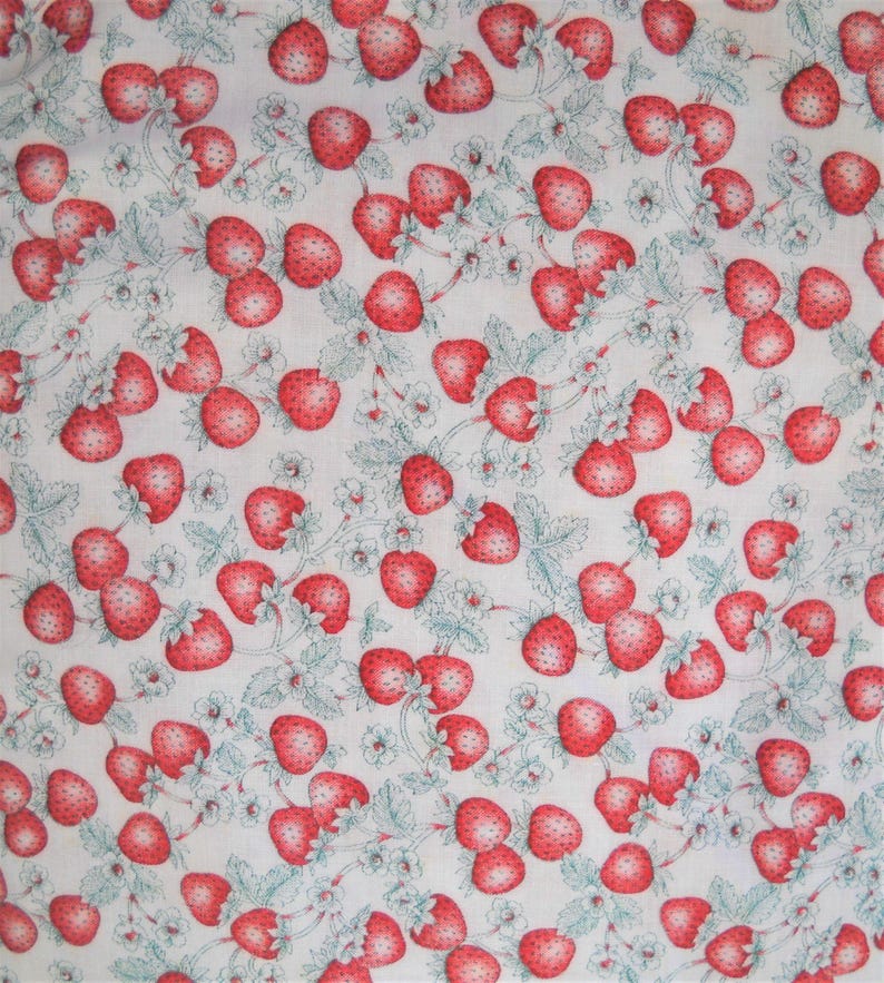 K&ouml;nnte beinhalten: Ein wei&szlig;er Stoff mit einem sich wiederholenden Muster aus roten Erdbeeren und gr&uuml;nen Bl&auml;ttern.