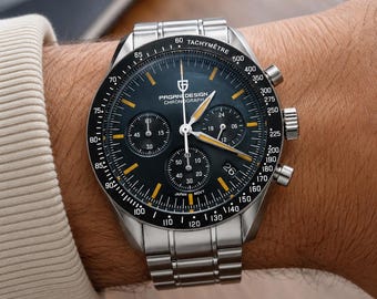 May include: A stainless steel chronograph wristwatch with a black dial, featuring three sub-dials, yellow hour markers, and a tachymeter scale on the bezel. The watch face displays the text PAGANI DESIGN CHRONOGRAPH and JAPAN MOVT.