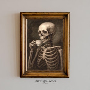 May include: A framed print featuring a skeletal figure holding a teacup. The artwork is in sepia tones, with the skeleton's rib cage and skull prominently displayed. The frame is gold-colored, and the print is labeled "Midnight Bloom Prints."