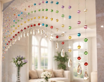 May include: A decorative beaded curtain with colorful crystal beads and teardrop-shaped pendants. The beads are in a rainbow of colors, including red, orange, yellow, green, blue, and purple. The curtain hangs in front of a window, adding a touch of elegance.