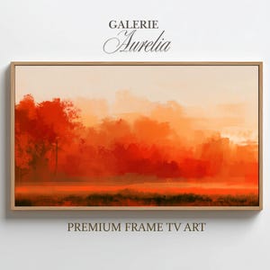 May include: A rectangular landscape painting in a light wood frame featuring a vibrant orange and red abstract forest scene. The text GALERIE Aurelia appears above the frame, and the text PREMIUM FRAME TV ART appears below the frame.