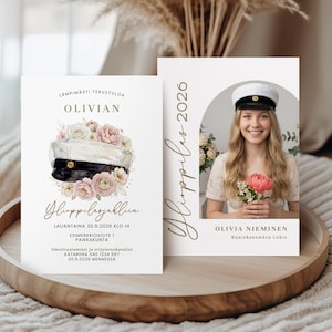 May include: Two graduation announcement cards on a wooden tray. The left card features text and a watercolor illustration of a graduation cap and flowers. The right card has a photo of a smiling woman holding flowers, with text and the year 2026.