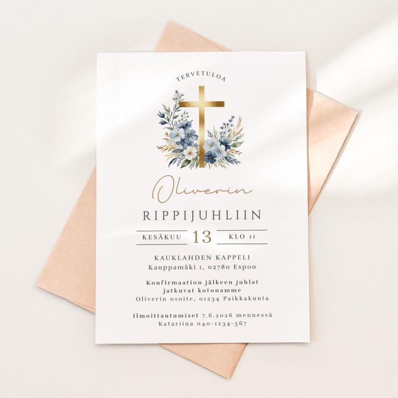May include: A white invitation card with gold text and a gold cross adorned with blue and white flowers. The card includes the text "Oliverin RIPPIJUHLIIN" and event details. The card is placed on a peach-colored envelope.