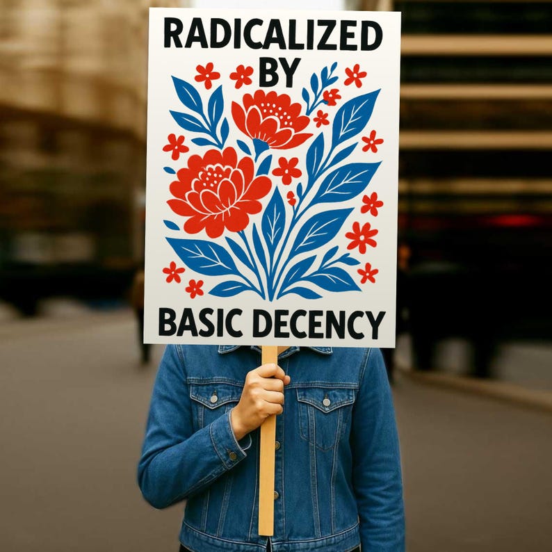 Puede incluir: Un cartel con las palabras "RADICALIZED BY BASIC DECENCY" en texto negro, sostenido por una persona. El cartel presenta un dise&ntilde;o floral con flores rojas y hojas azules. La persona lleva una chaqueta vaquera azul.