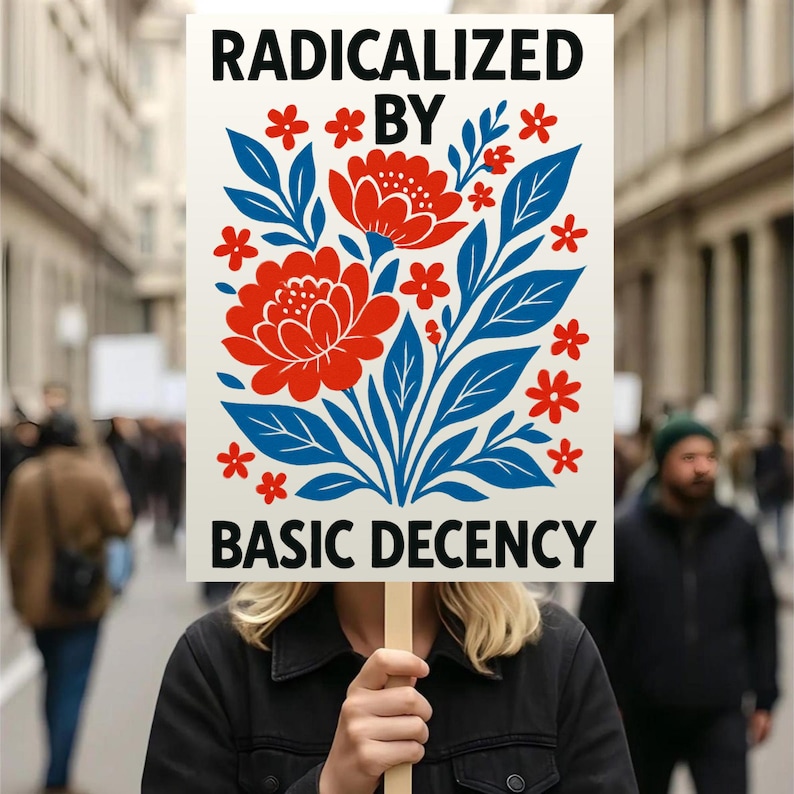 Puede incluir: Un cartel con las palabras "RADICALIZED BY BASIC DECENCY" en negro. El cartel presenta un dise&ntilde;o floral con flores rojas y hojas azules. El fondo es una escena callejera borrosa.