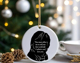 May include: White ceramic Christmas ornament with a black silhouette of a person's head and shoulders. The ornament has a gold string for hanging and features the text "You must allow me to tell you how ardently I admire and love you."