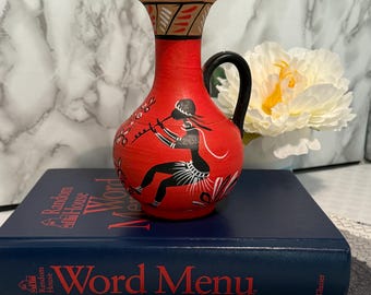Vintage red tribal art pottery pitcher, flute player motif, boho decor vase