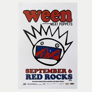 Puede incluir: Cartel de concierto de Ween con el invitado especial Meat Puppets. El cartel presenta una cara de dibujos animados con una escena de montaña dentro de su boca. El texto dice "September 6 Red Rocks" en rojo y azul.